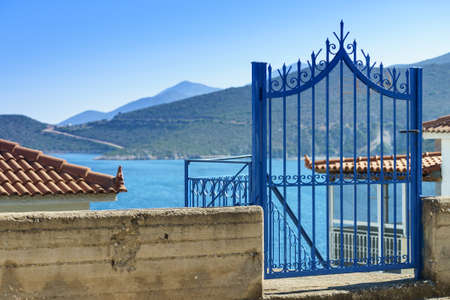 Typical Greek architecture details concept. Blue fence outdoor house during summer weather.の写真素材