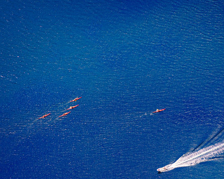 Tourism vacation and travel. Mountains fjord in Norway and people kayaking on water.