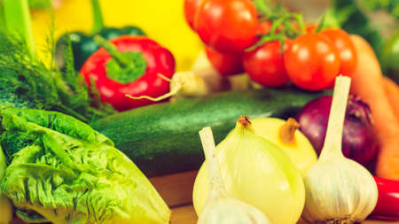 Many healthy colorful vegetables on kitchen table. Dieting, vegetarian local fresh food, natural source of vitamins.の写真素材