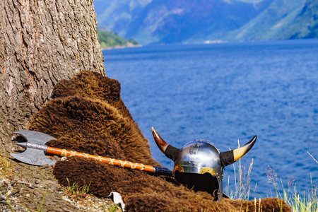 Viking helmet with axe on fjord shore in Norway. Tourism and traveling conceptの写真素材