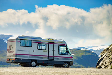 Camper car in norwegian mountains. Traveling, holidays and adventure concept.の写真素材