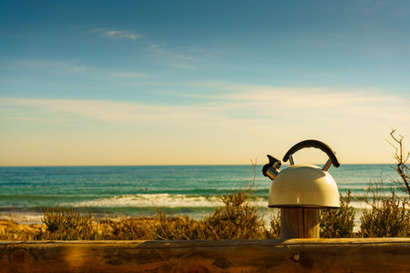 Kettle outdoor on sea shore. Travel, camping on nature