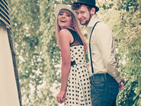 Summer holidays love relationship and dating concept - romantic playful couple retro style flirting outdoorの写真素材