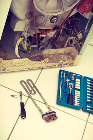 Mechanical industrial domestic electrical engineering concept. Washing machine during repair. Broken...