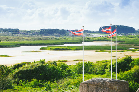 National tourist county route road 44 Jaeren, sothern Norway. Coastal landscape with norwegian flag...