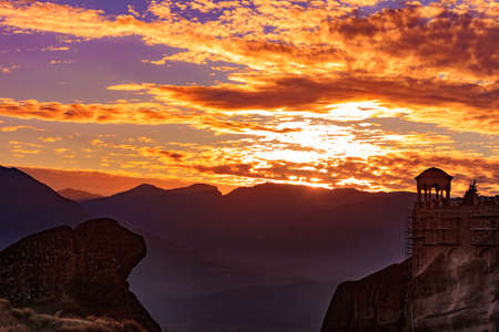 Scenic sunset evening sky over holy Varlaam monastery on cliff in Meteora, Thessaly Greece. Greek destinationsの写真素材