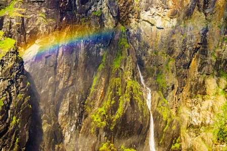 Voringsfossen waterfall with rainbow in summer, Mabodalen valley Norway. National tourist Hardangervidda route, touristroad 7, Eidfjord sightseeing tour.の写真素材