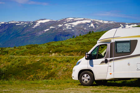 Tourism vacation and travel. Camper car in green summer mountains landscape. National tourist route Aurlandsfjellet.の写真素材