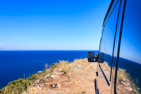 View from camper van window on beautiful calm blue pure sea ocean water.の写真素材