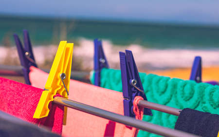 Camping on beach, adventure concept. Clothes clean washing laundry hanging to dry on clothesline outdoor against sea.の写真素材