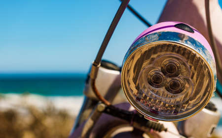 Female bicycle outdoor parked on beach sea shore. Lamp element. Holidays, sport and summer recreation.の写真素材