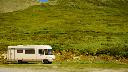 Tourism vacation and travel. Camper car in green summer mountains landscape. National tourist route...