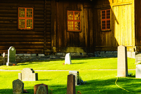 LOM, NORWAY - JULY 7, 2018: Graveyard with old tombstones around Lom Stave Church in Oppland county, Norway.のeditorial素材