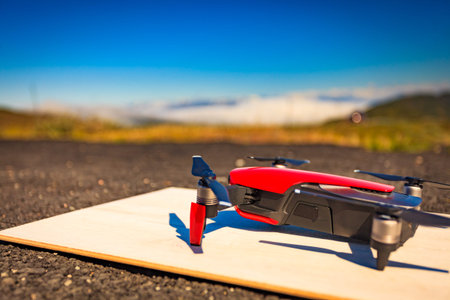 Start the drone from launch pad. Modern small copter with camera against nature. Technological...