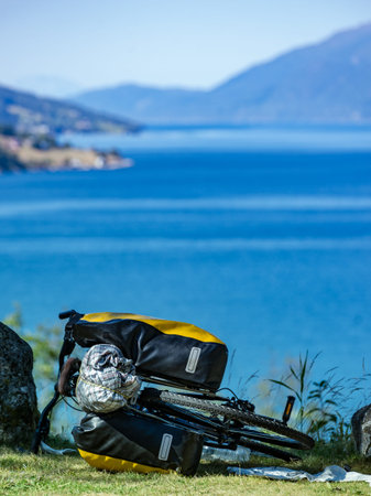 Mountain bicycle with attached bag saddlebag against nature, mountains fjord landscape in Norway