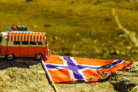 SOGNEFJELLET, NORWAY - JULY 7, 2018: Miniature scale model hippy VW van with norwegian flag on mountains nature, tourist route Sognefjelletのeditorial素材
