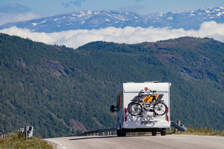 VIKAFJELLET, NORWAY - JULY 5, 2018: Burstner camper with bicycles on road across Vikafjellet between...