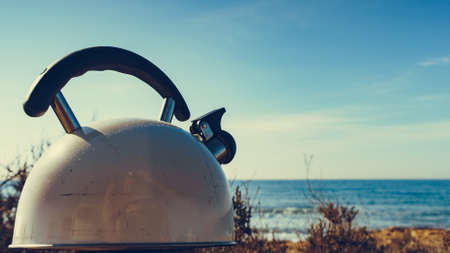 Kettle outdoor on sea shore. Travel, camping on natureの写真素材