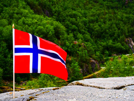 Norwegian flag waving outdoor on green natureの写真素材