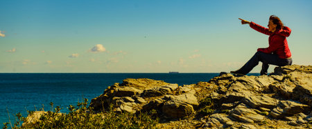 Tourist woman on spanish rocky coastline in Murcia region. Mediterranean Sea coast landscape, Calblanque Regional Park.の写真素材