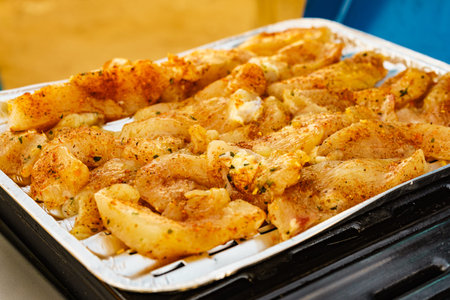 Closeup chicken meat on barbecue gas grill. Barbeque dinner outdoor.