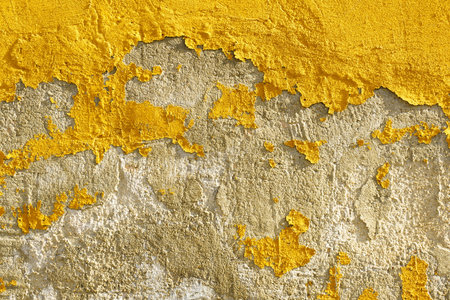Old weathered painted yellow color peeling wall grunge background
