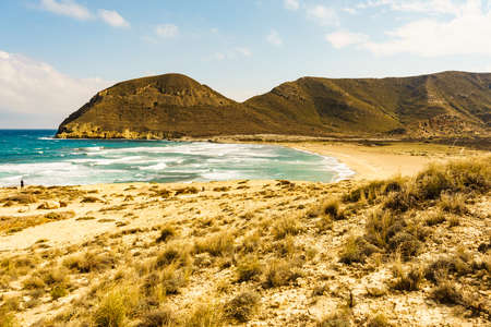 Seascape. Beach El Playazo, Cabo de Gata, province Almería, Andalusia Spain. Rocky sea shore with waves. Tourist site.の写真素材