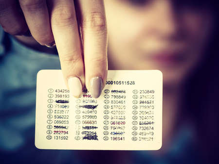 Woman holding card with codes for online transfers. Internet shopping, account protection, banking concept.の写真素材
