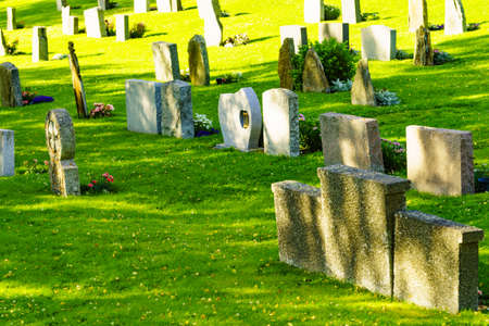 LOM, NORWAY - JULY 7, 2018: Graveyard with old tombstones around Lom Stave Church in Oppland county, Norway.のeditorial素材
