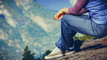 Tourist woman on the mountain top looking at view of mountains, Norway. National tourist scenic...