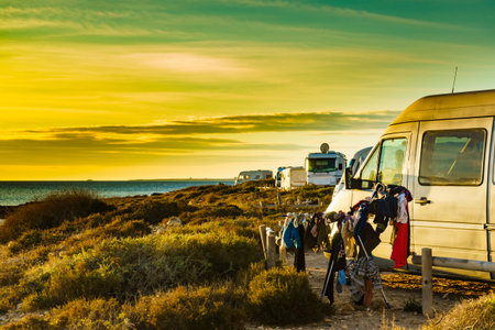 Camping on beach, adventure concept. Clothes hanging to dry on laundry line outdoor by camper car