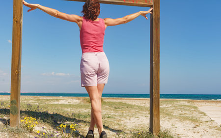 Mature woman walking on beach, relaxing at San Pedro del Pinatar park, Murcia Spain. Summer...