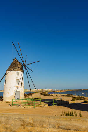 Old historic windmill in salt marshes at San Pedro del Pinatar park, Murcia Spain. Tourist attractionの写真素材