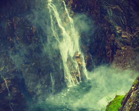 Voringsfossen waterfall, green summer mountains, Mabodalen canyon Norway. National tourist...