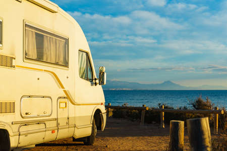 Camper, recreational vehicle on mediterranean coast in Spain. Camping on nature beach. Holidays and travel in motor home.の写真素材
