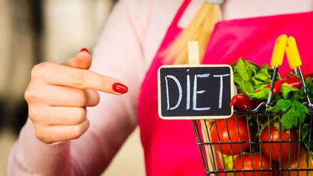 Shopping basket with diet sign and many colorful vegetables. Healthy eating lifestyle, vegetarian food.の写真素材