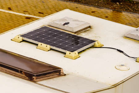 Solar photovoltaic panels, charging batteries on caravan roof. Traveling with mobile home.の写真素材