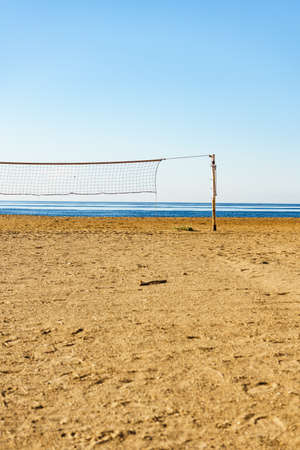 Volleyball summer sport equipment. Net netting wire on sandy beach outdoor. Active lifestyle.の写真素材