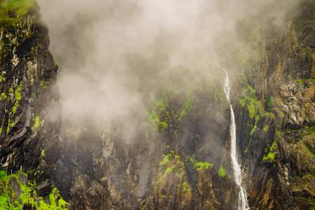 Voringsfossen waterfall, green summer mountains, Mabodalen canyon Norway. National tourist...
