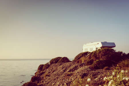Camper car camping on cliff above Cabezo Negro beach, spanish landscape along Almeria coast. Traveling in motorhome.の写真素材