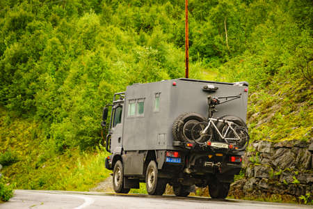 GEIRANGER, NORWAY - JULY 29, 2018: Norway. Chinese big off-road camper car 4x4, rv motor home with bicycles on back on roadside, Norwayのeditorial素材