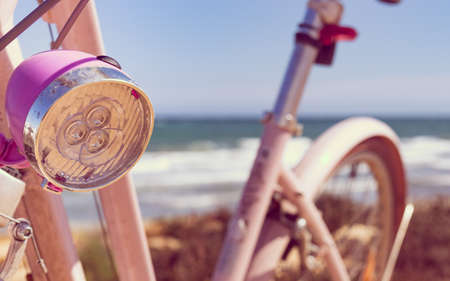 Female bicycle outdoor parked on beach sea shore. Lamp element. Holidays, sport and summer recreation.の写真素材