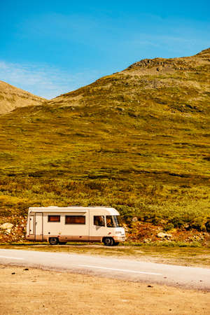 Tourism vacation and travel. Camper car in green summer mountains landscape. National tourist route Aurlandsfjellet.の写真素材