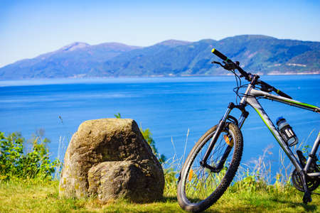 ERESFJORD, NORWAY - JULY 27, 2018: Mountain bicycle against nature, mountains fjord landscape. Eidsvag More og Romsdal county, Norway.のeditorial素材