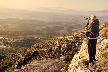 Male tourist with camera taking travel photo from coastal spanish landscape, Mesa Roldan location in...