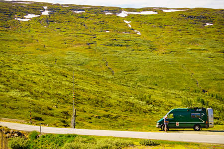 Tourism vacation and travel. Male tourist at camper van in summer mountains. National tourist route Aurlandsfjellet.の写真素材