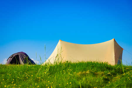 Camping. Tent on nature against blue sky. Holidays and travel.の写真素材