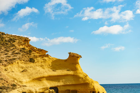 Cocedores Beach with yellow sand formations at Mediterranean sea, Murcia region Spain.