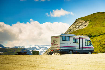 AURLANDSFJELLET, NORWAY - JUNE 27, 2018: Benimar camper car on road, summer mountains landscape. National tourist route Aurlandsfjellet.のeditorial素材