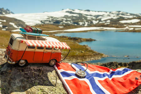 SOGNEFJELLET, NORWAY - JULY 7, 2018: Miniature scale model hippy VW van with norwegian flag on mountains nature, tourist route Sognefjelletのeditorial素材